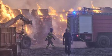 Bomberos y vecinos de Bóveda del Río Almar trabajan en la extinción de un gran incendio en una granja de vacuno de leche